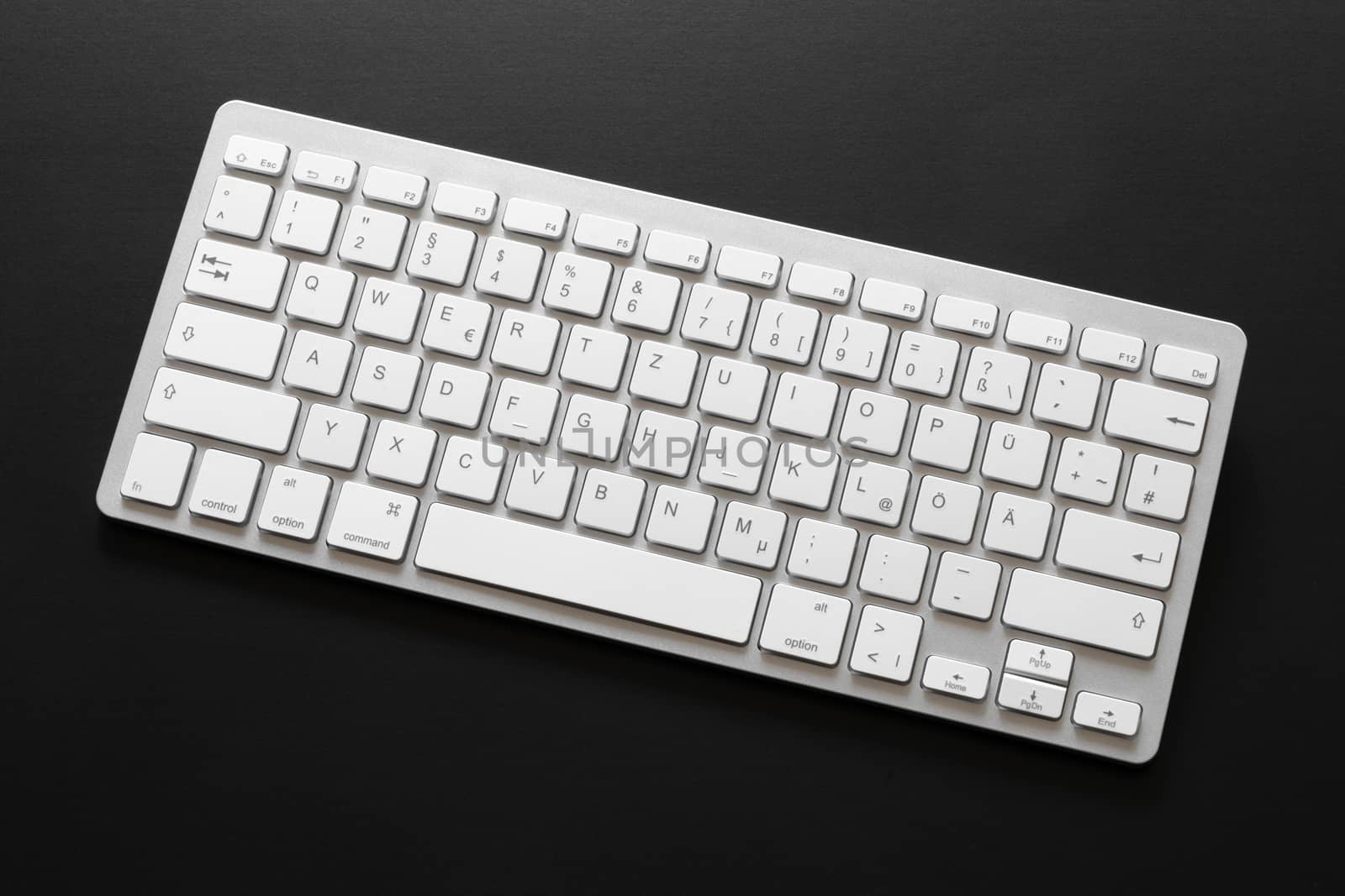 typical computer keyboard isolated on black background by magann