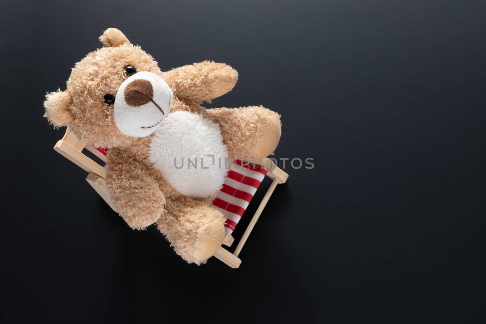 teddy bear isolated on black background by magann