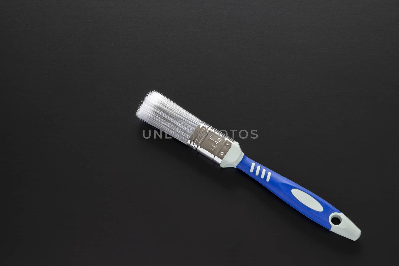 A typical one inch brush isolated on black background