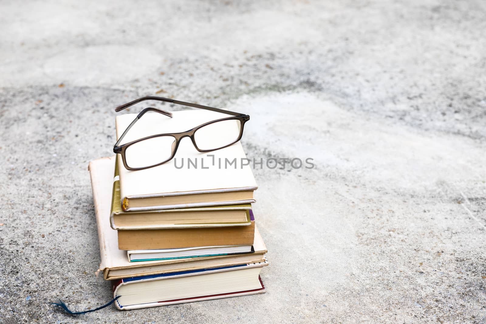 books and reading glasses by magann