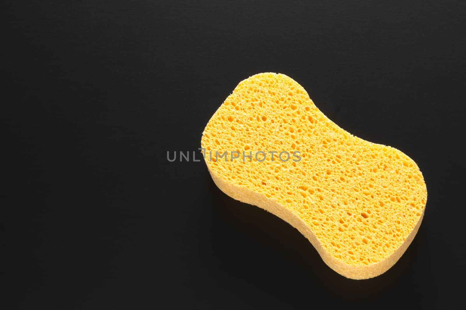 An image of a yellow sponge isolated on black background