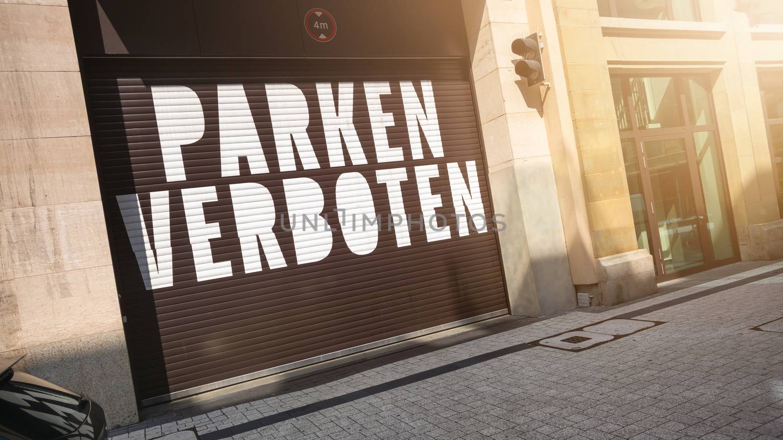 the text parking forbidden in german language on a garage door by magann