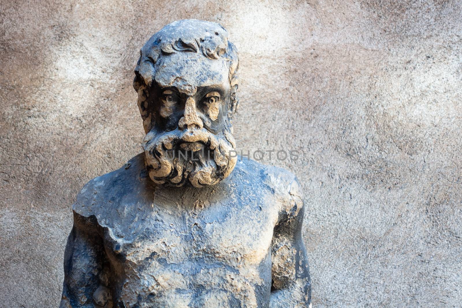 An image of an old male statue