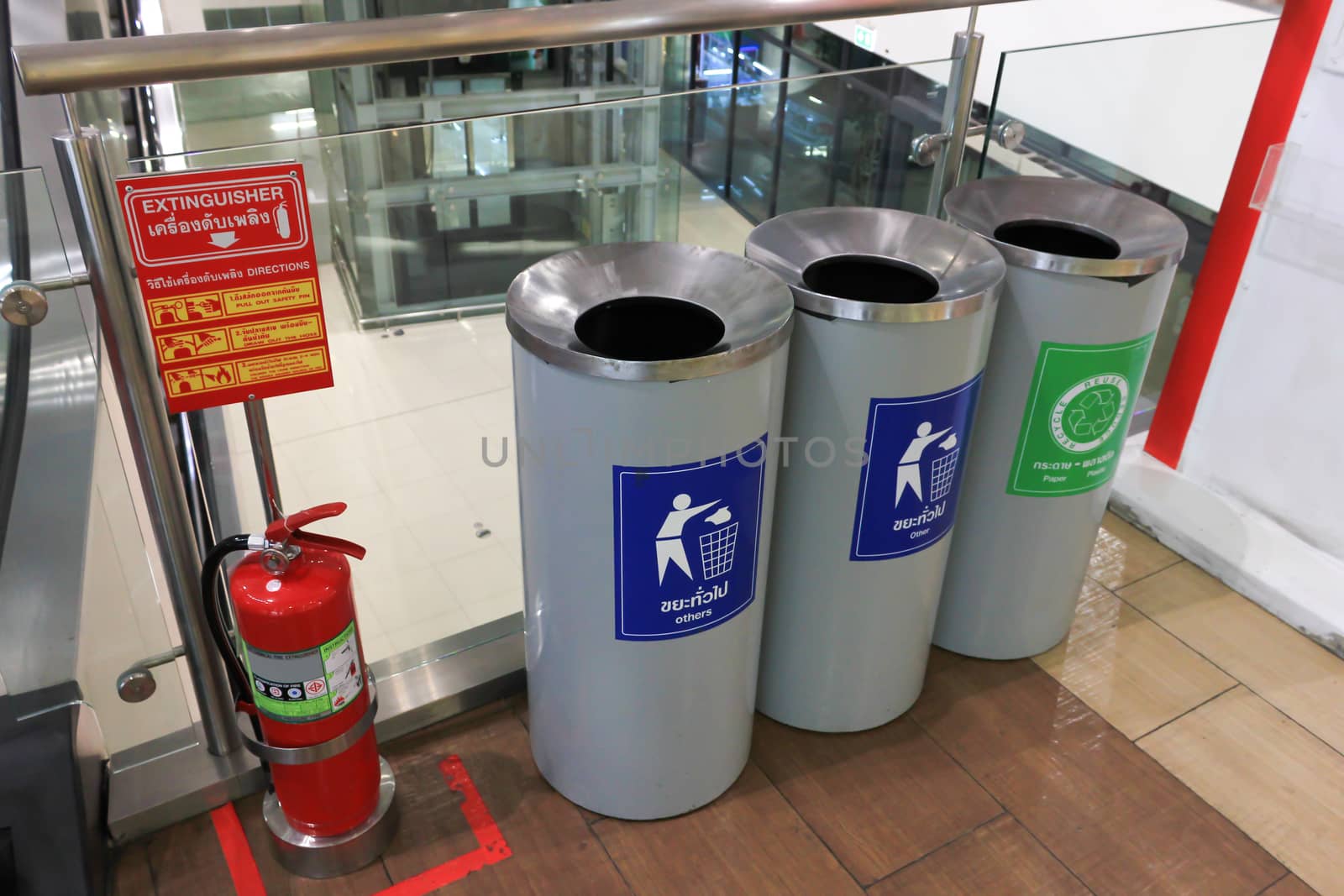 Three bins recycling symbol in shopping mall