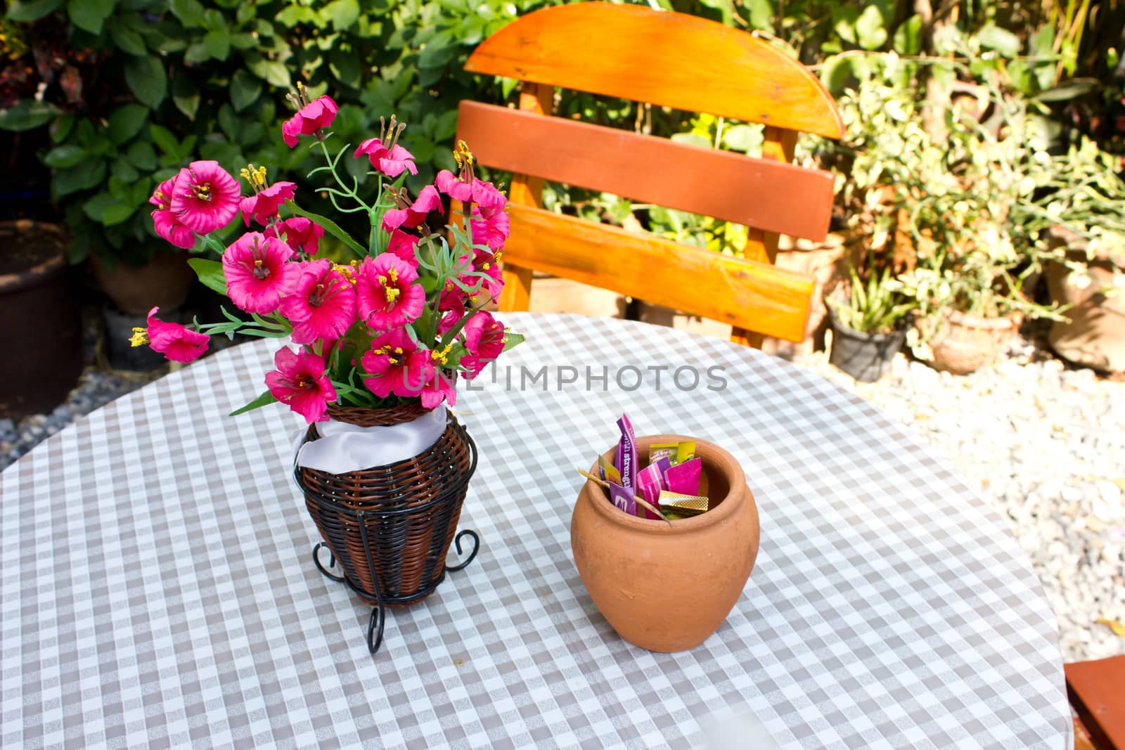 flower on table and chairs at a backyard