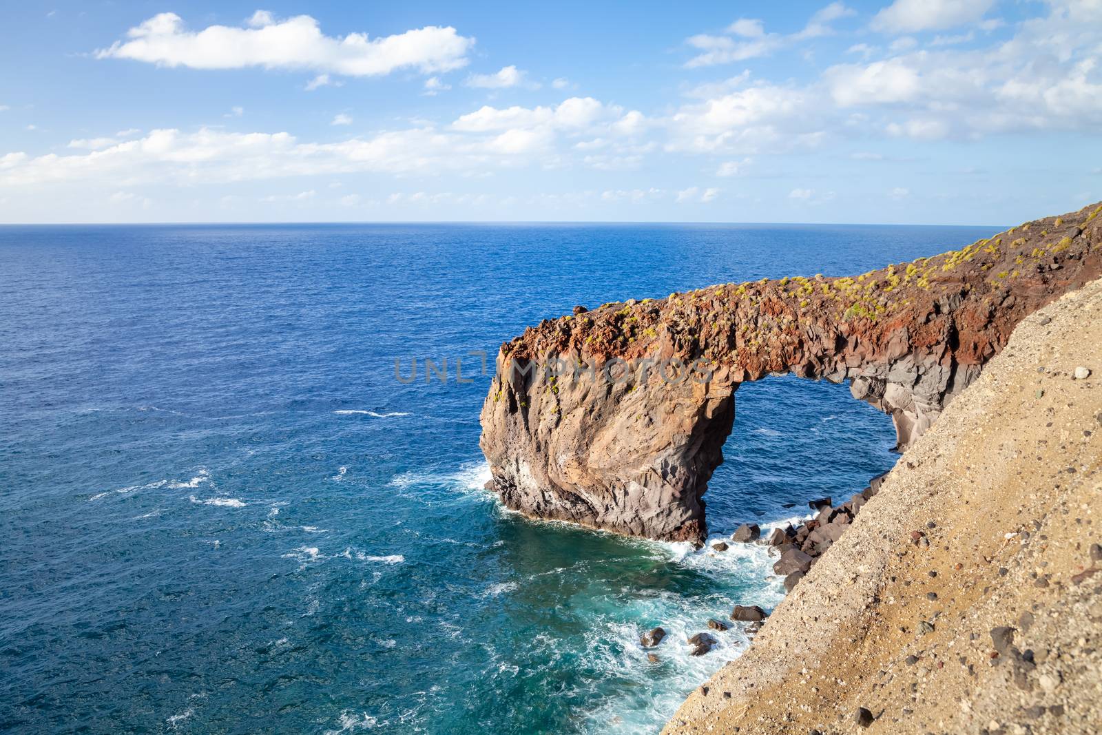 An image of the famous rock arch Punta Perciato