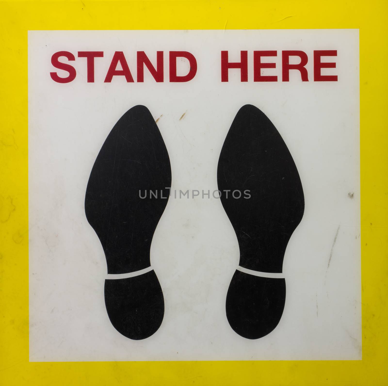 Yellow color Sticker Stand here foot label