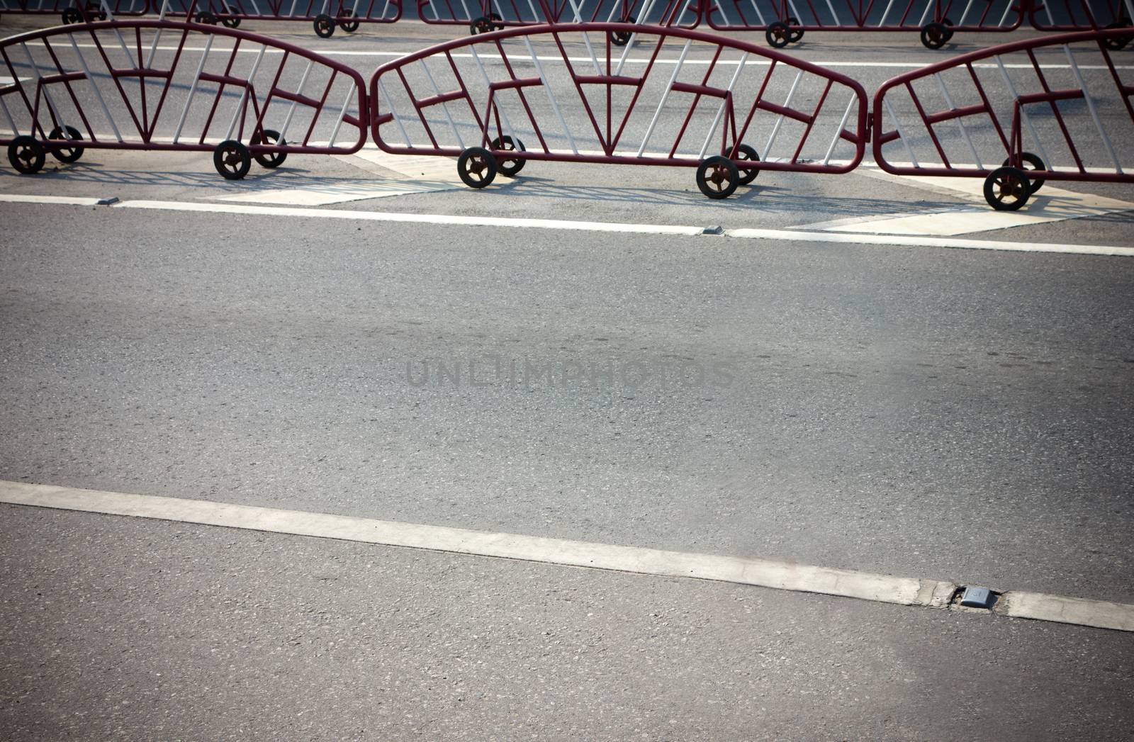 Red and white steel barrier on wheel on the wall