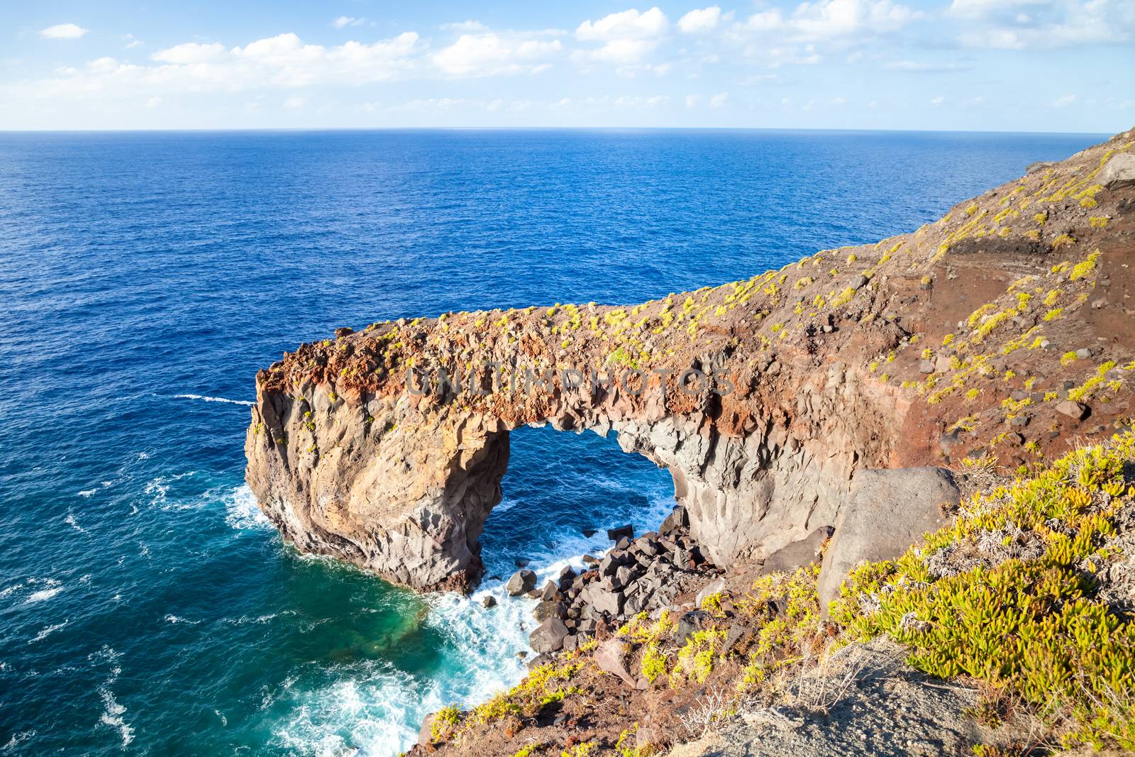 An image of the famous rock arch Punta Perciato