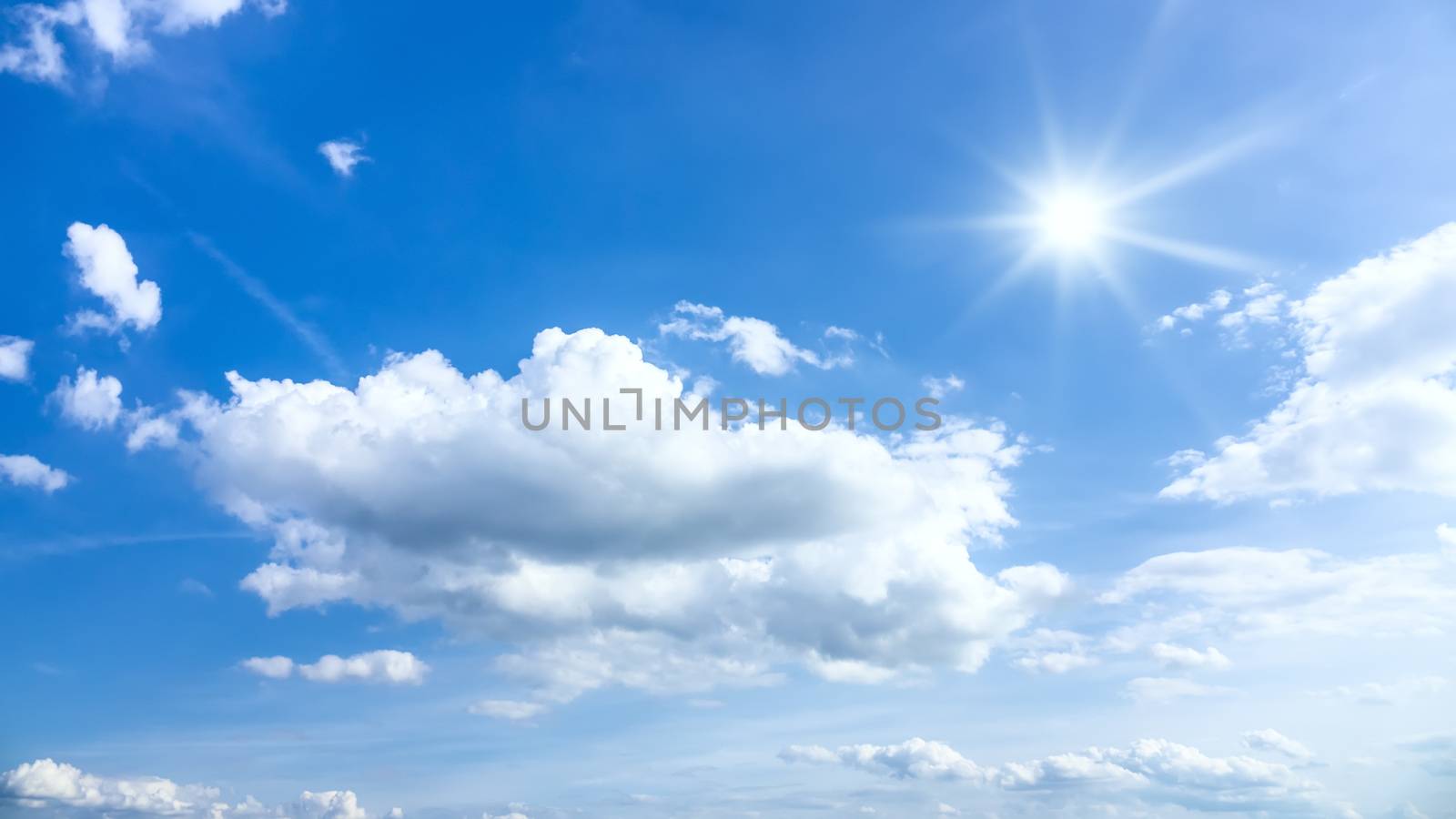 An image of a typical beautiful blue sky sun clouds background