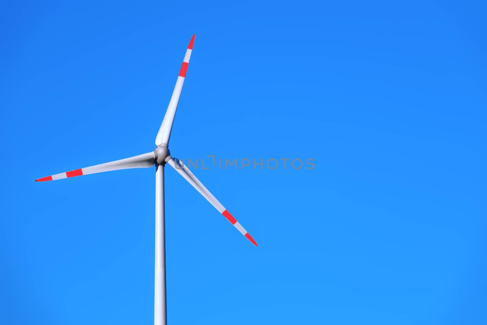 An image of a wind energy detail blue sky