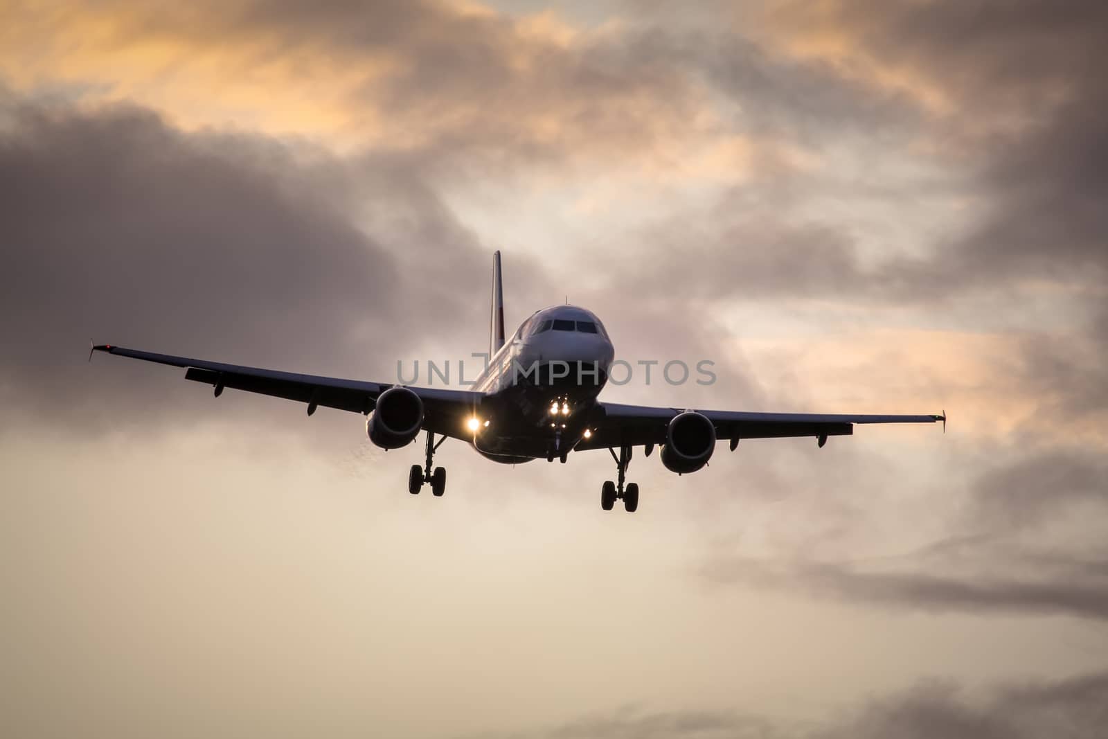 A photography of a jet air plane in sunset sky