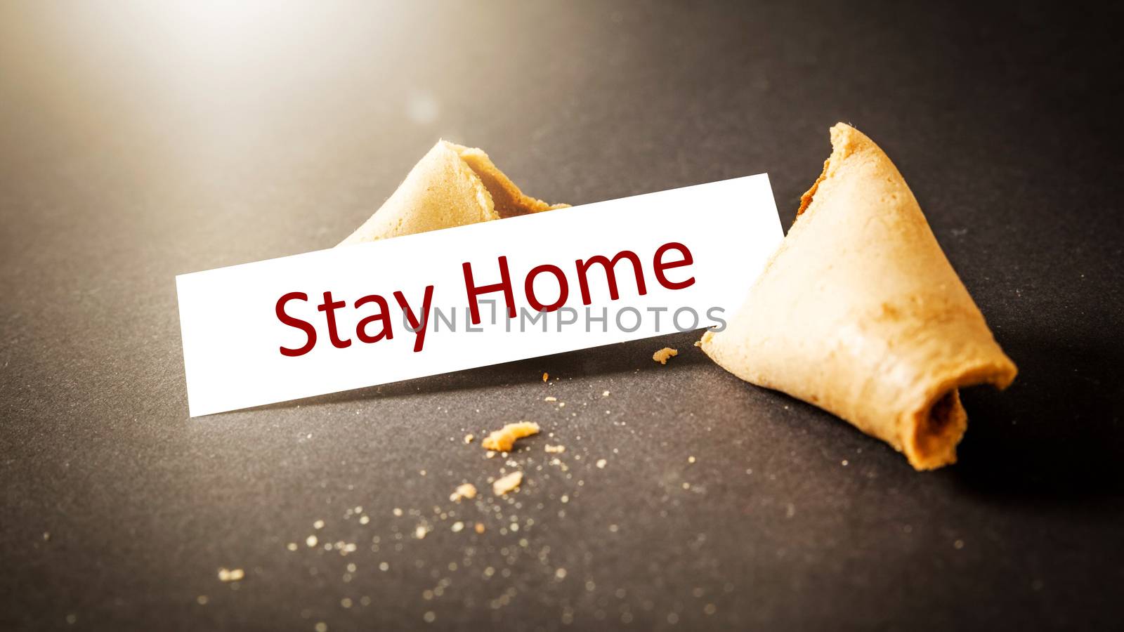 a fortune cookie with message stay home by magann
