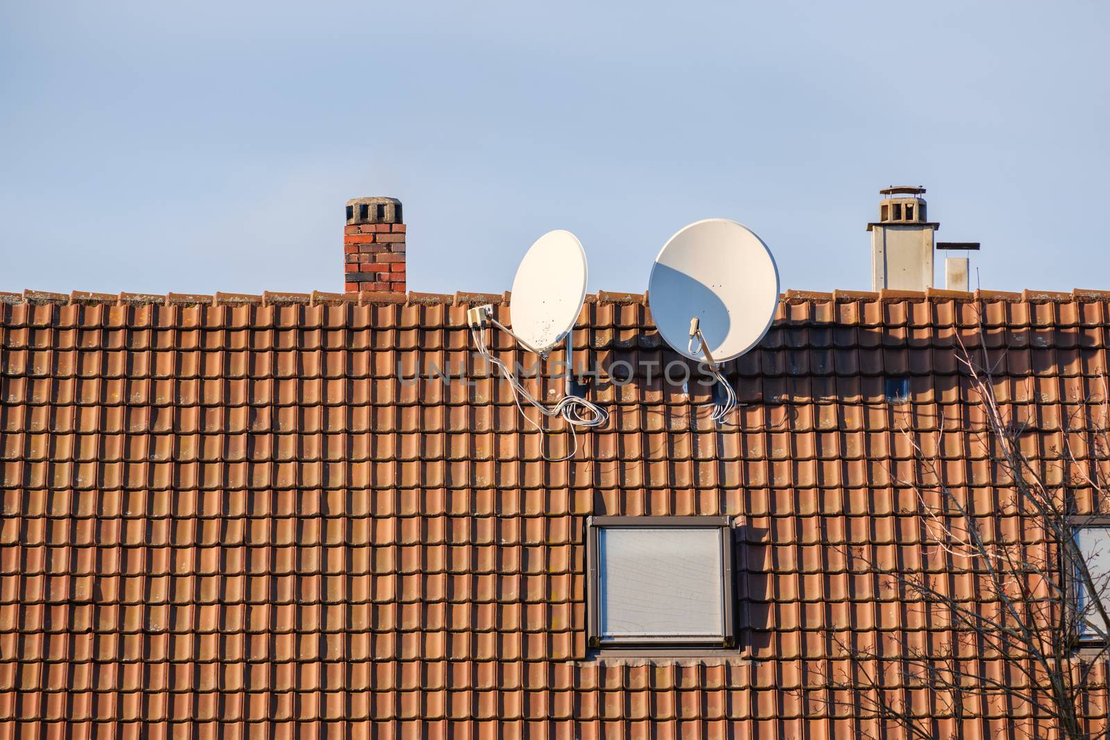 An image of a satellite dish at a roof with space for your text