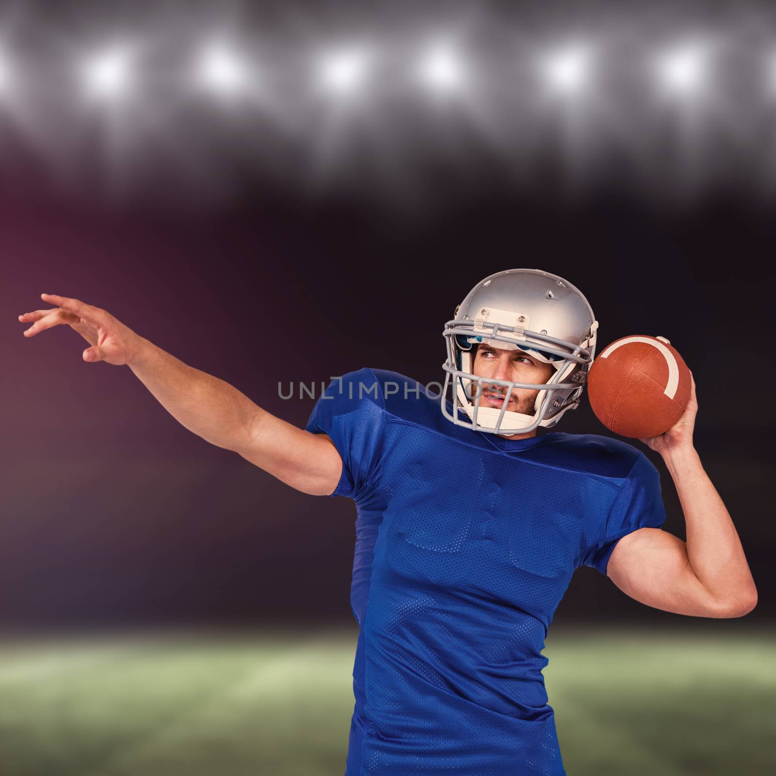 American football player about to throw the ball against rugby pitch
