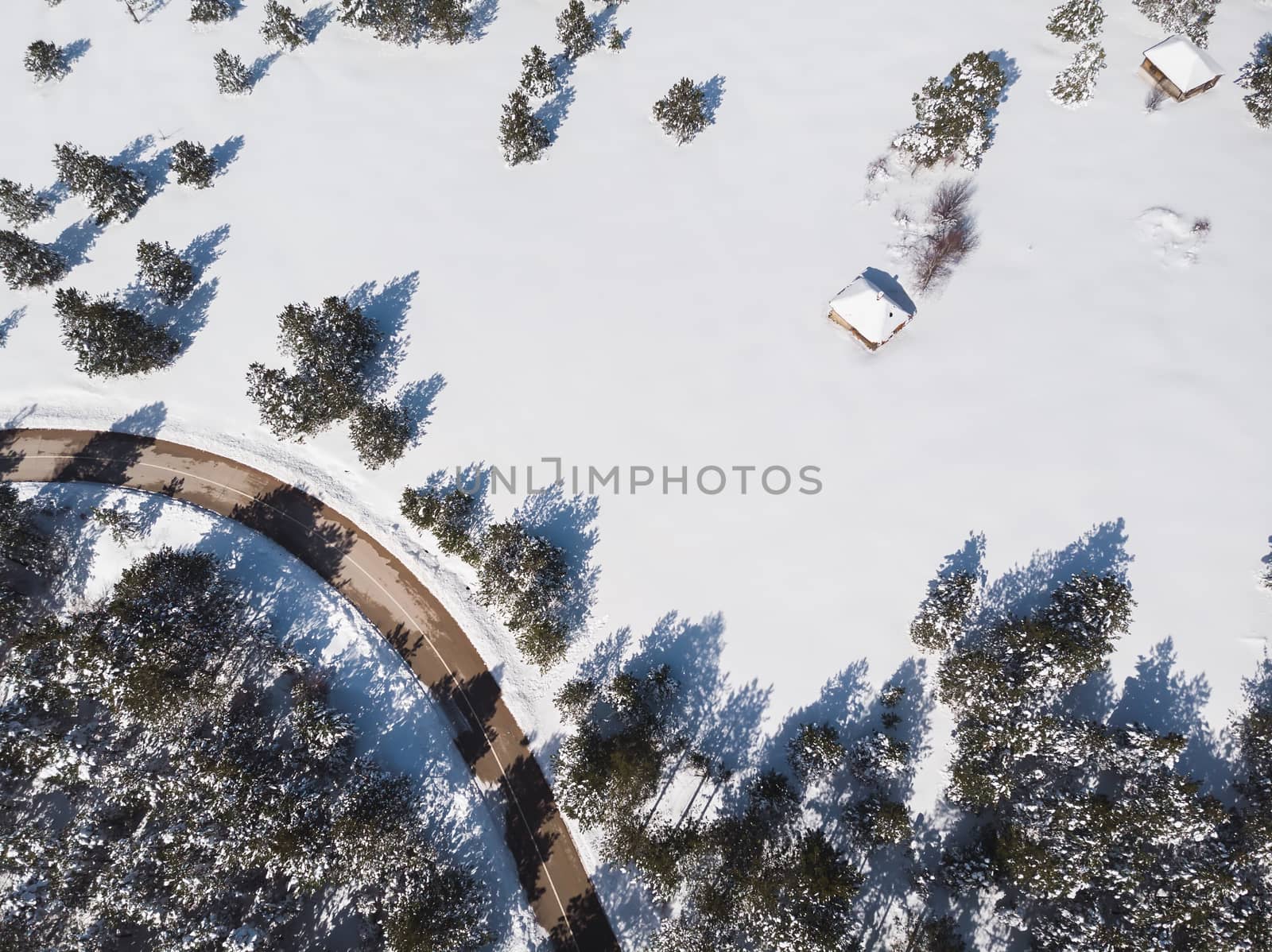 Snowy Mountain Landscape. Aerial view of a forest and road under the snow, copy space by Slast20