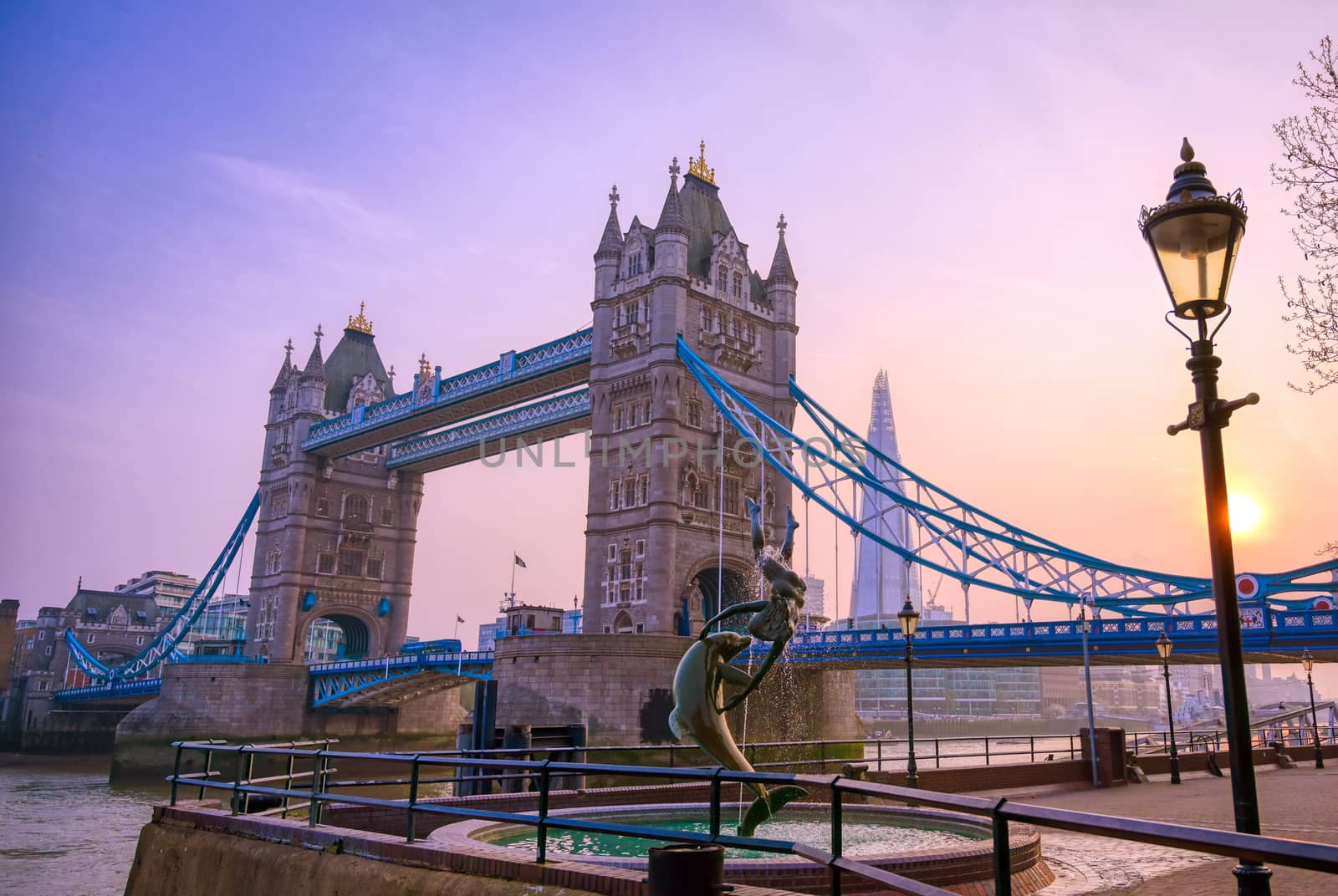 London, United Kingdom - April 17, 2019 : View of Tower Bridge on the River Thames with the Girl with Dolphin fountain, created by David Wynne in 1973.