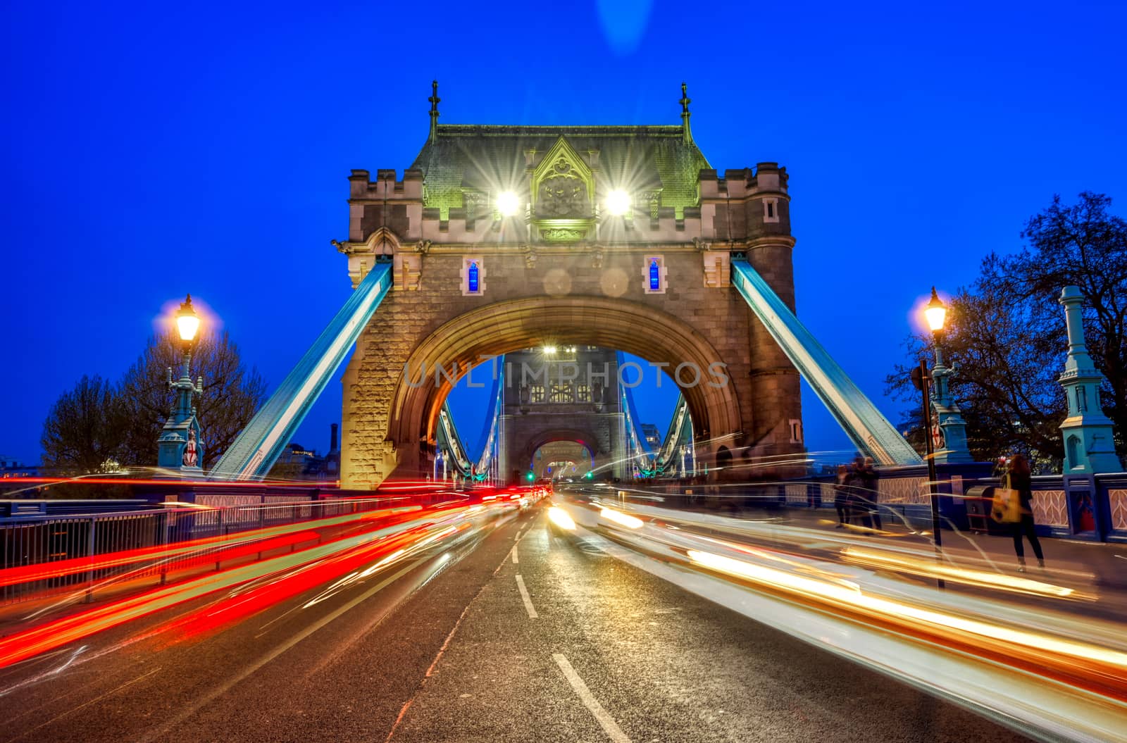 Vehicles pass over Tower Bridge across the River Thames in London, UK.