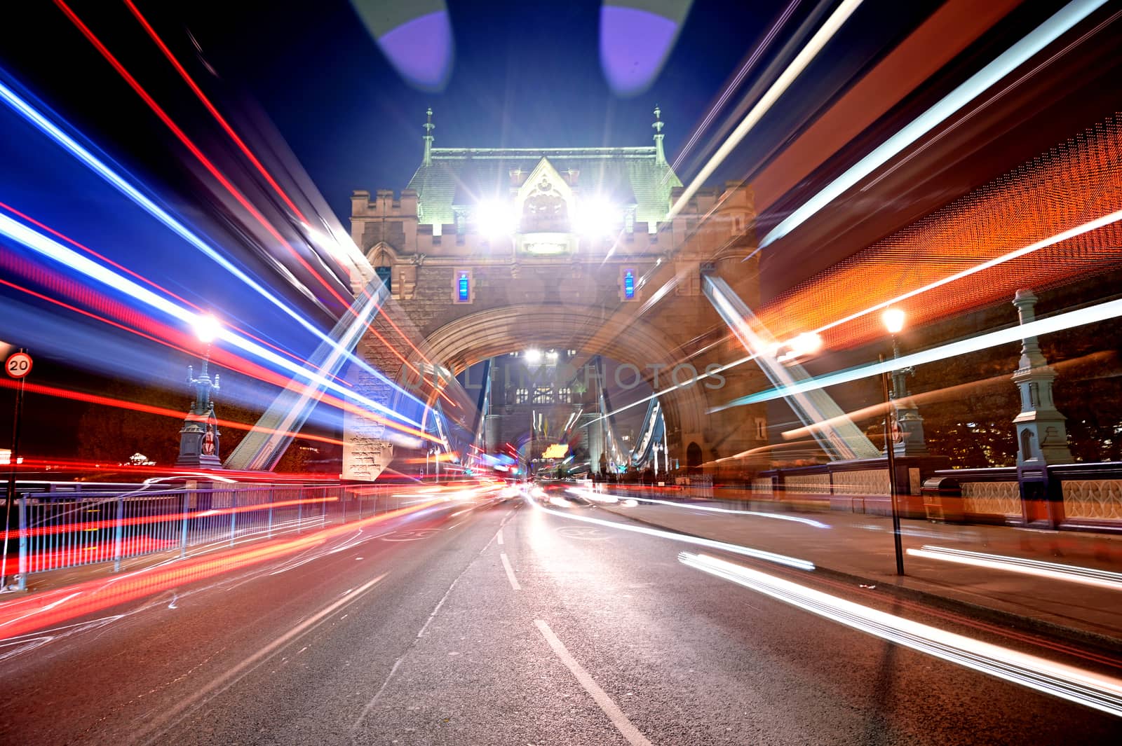 Vehicles pass over Tower Bridge across the River Thames in London, UK.