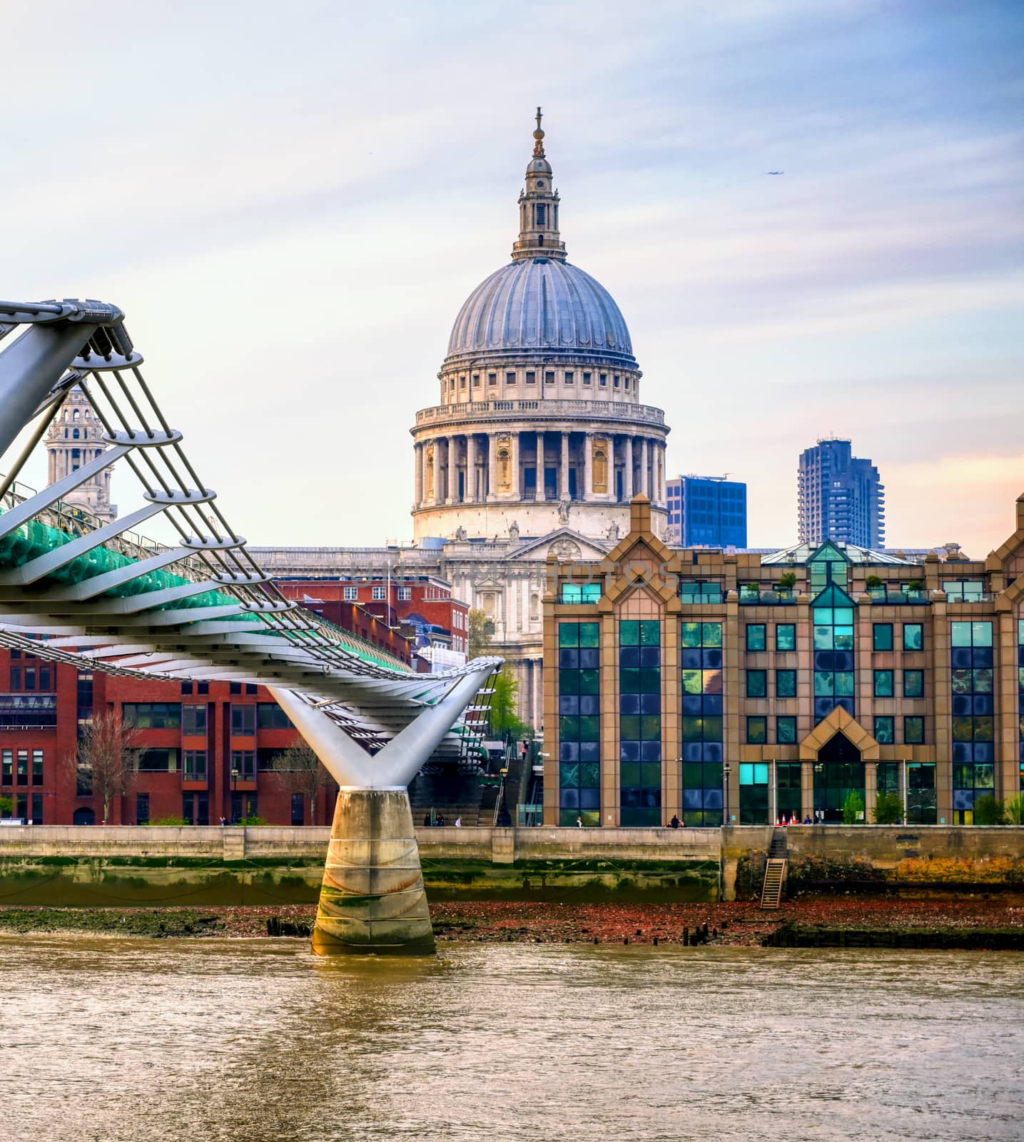 St. Paul's Cathedral across Millennium Bridge and the River Thames in London, UK.