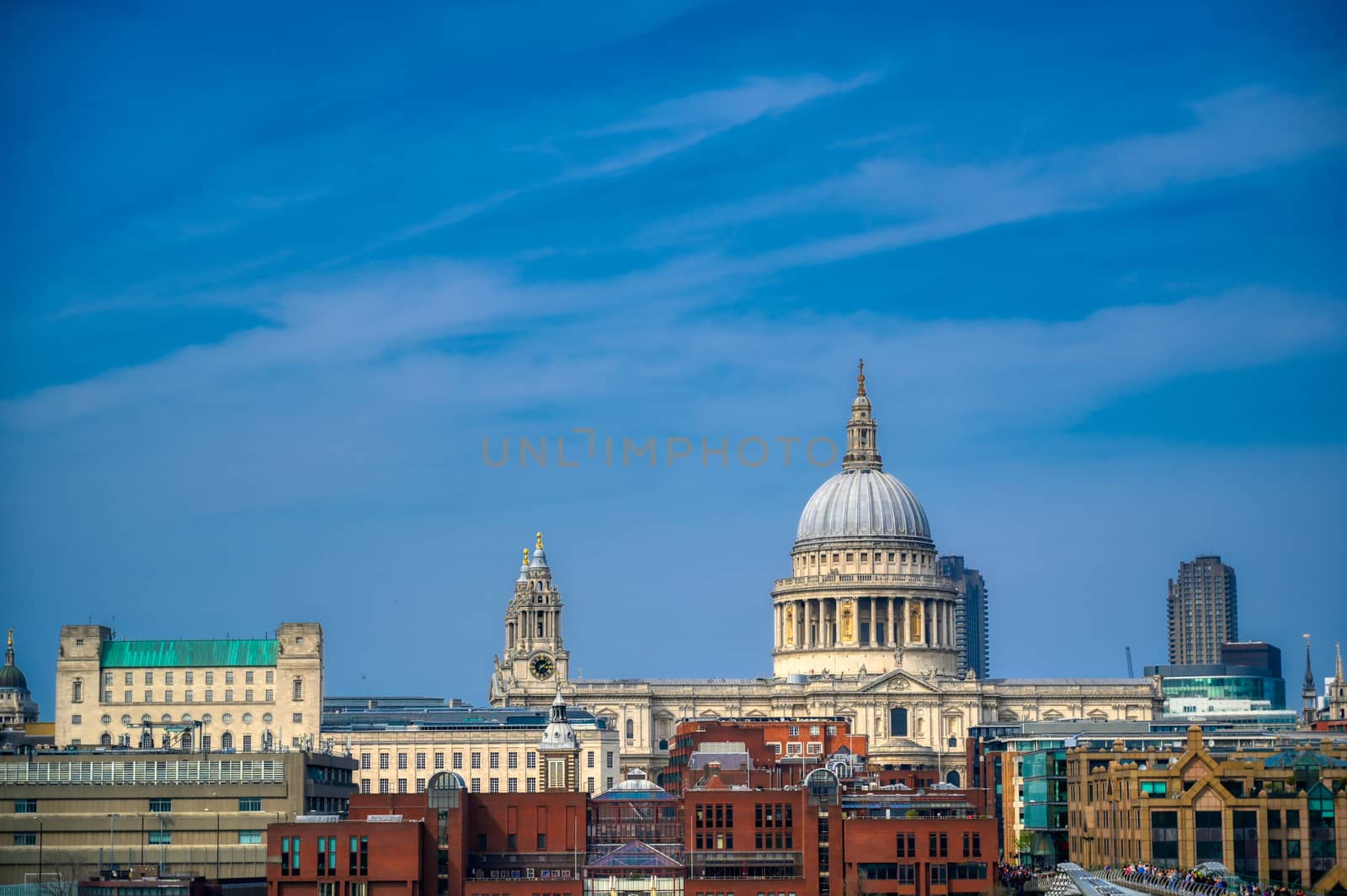 London, United Kingdom - April 18, 2019 - St. Paul's Cathedral across Millennium Bridge and the River Thames in London, UK.