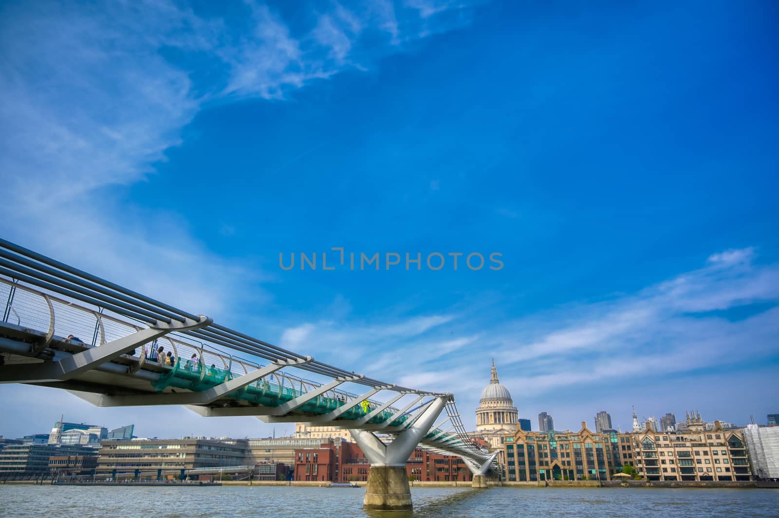 London, United Kingdom - April 18, 2019 - St. Paul's Cathedral across Millennium Bridge and the River Thames in London, UK.