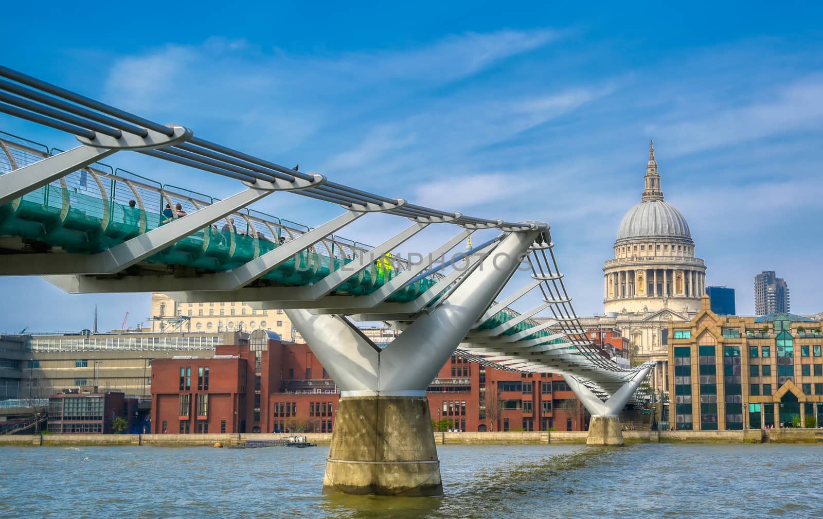 London, United Kingdom - April 18, 2019 - St. Paul's Cathedral across Millennium Bridge and the River Thames in London, UK.