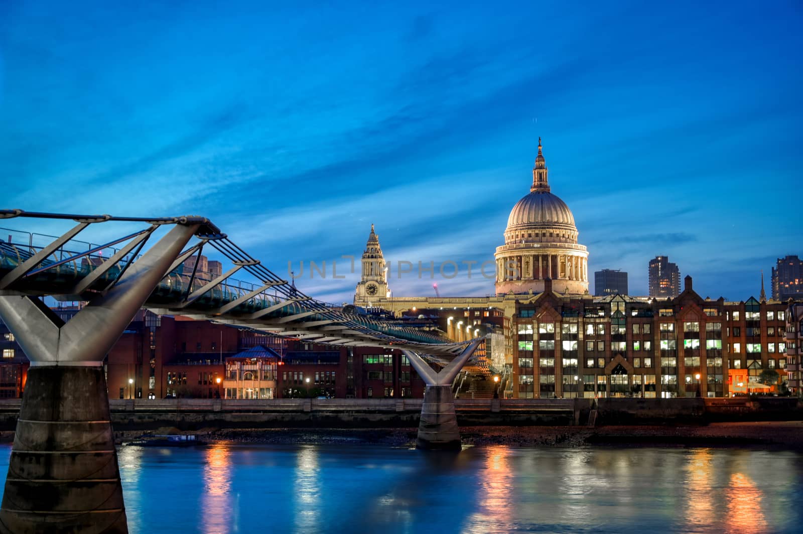 St. Paul's Cathedral across Millennium Bridge and the River Thames in London, UK.