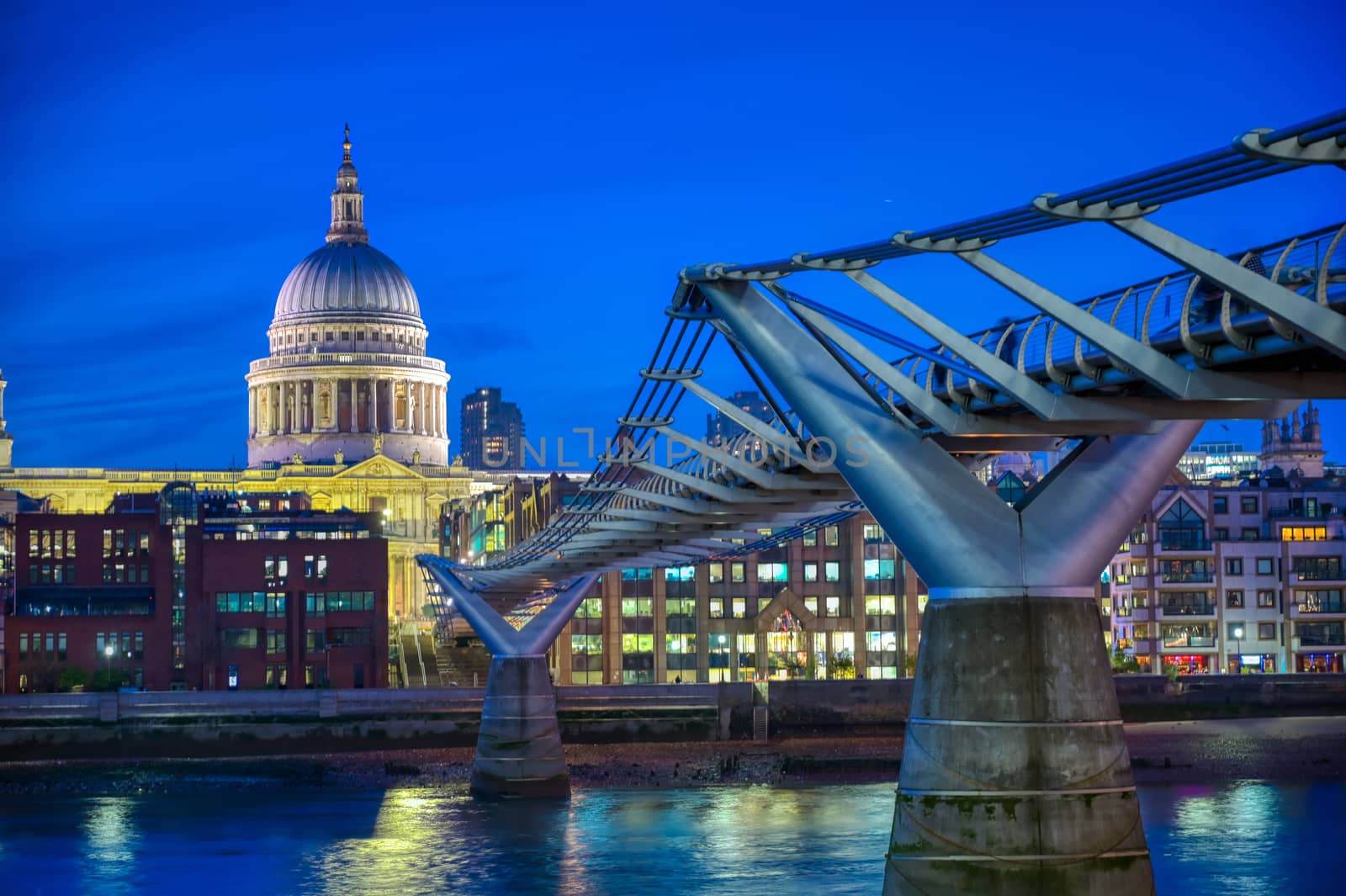 St. Paul's Cathedral across Millennium Bridge and the River Thames in London, UK.