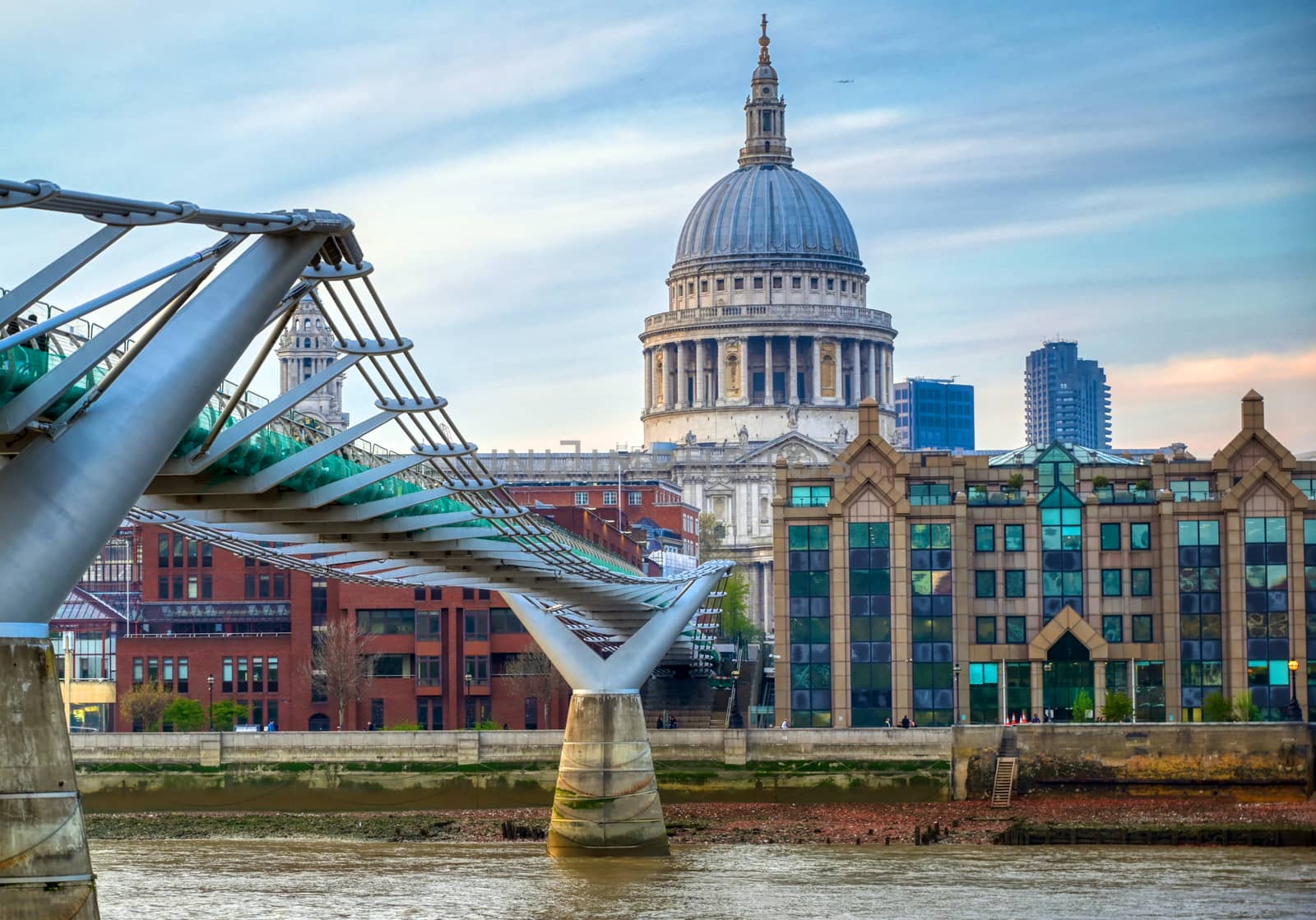 St. Paul's Cathedral across Millennium Bridge and the River Thames in London, UK.