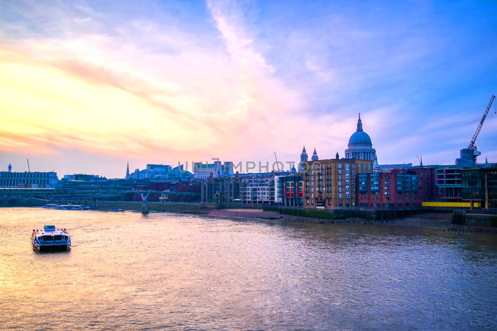 St. Paul's Cathedral across Millennium Bridge and the River Thames in London, UK.