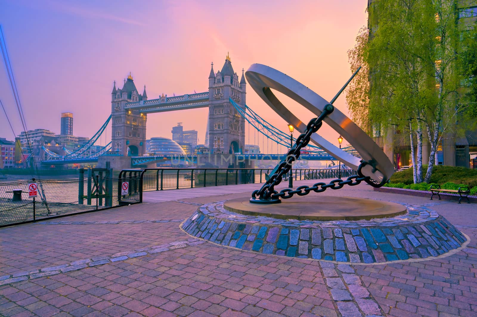 London, United Kingdom - April 17, 2019 : View of Tower Bridge on the River Thames with the sundial, titled Timepiece, that was designed by Wendy Taylor in 1973.