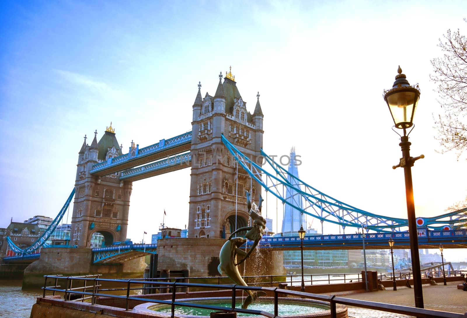 London, United Kingdom - April 17, 2019 : View of Tower Bridge on the River Thames with the Girl with Dolphin fountain, created by David Wynne in 1973.