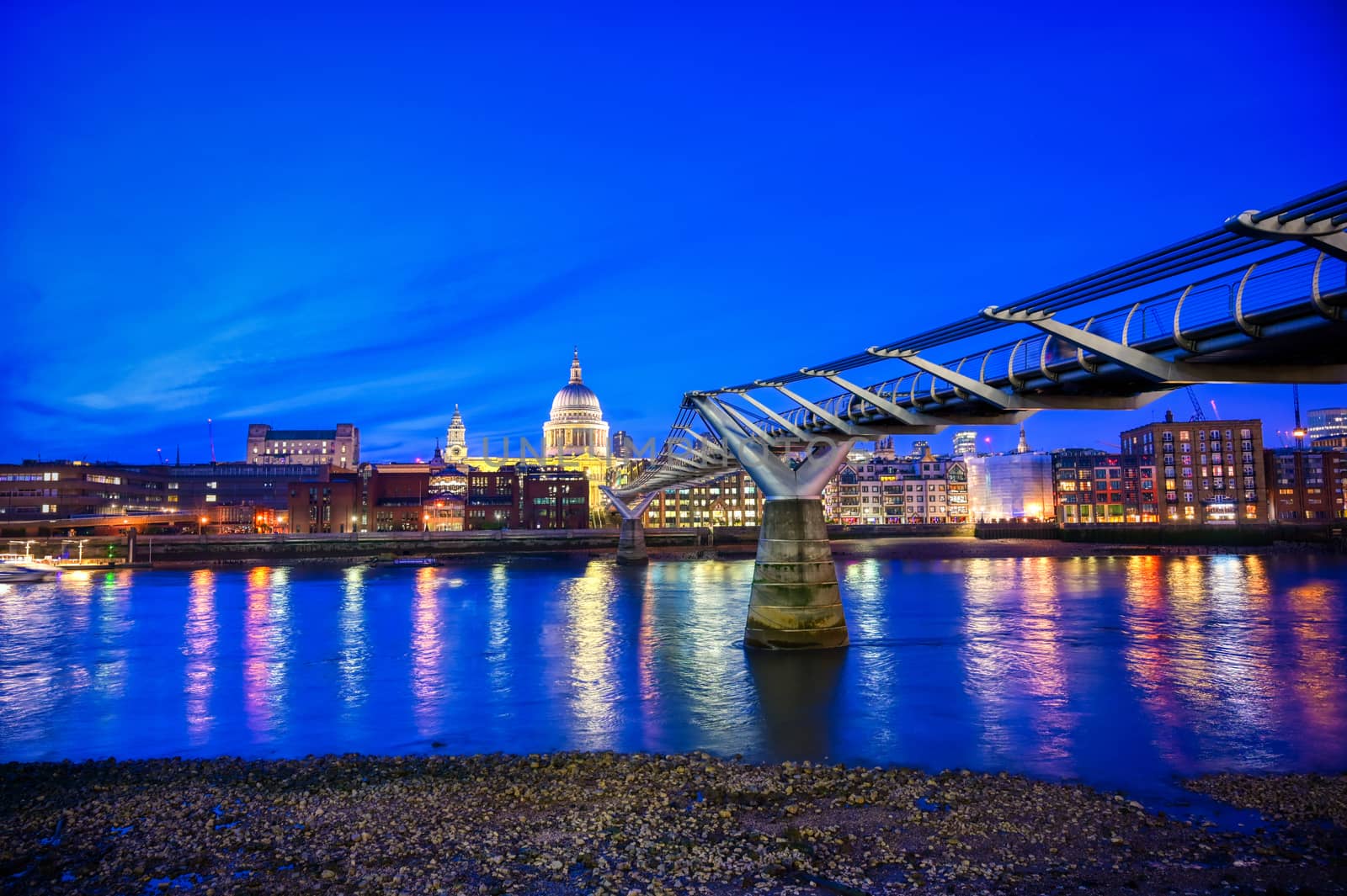 St. Paul's Cathedral across Millennium Bridge and the River Thames in London, UK.