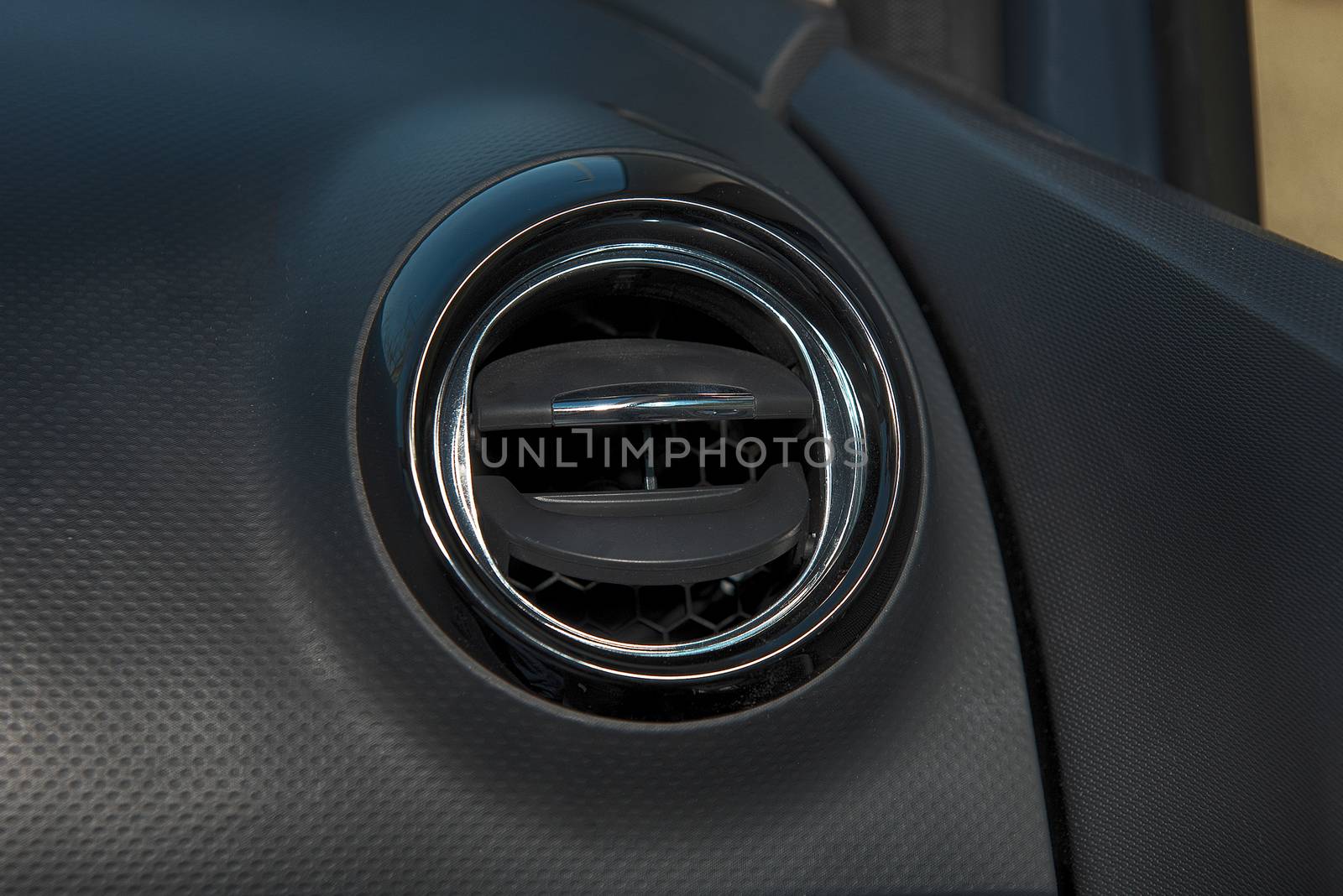 Interior of a car with closeup of  ventilation grille for air conditioning