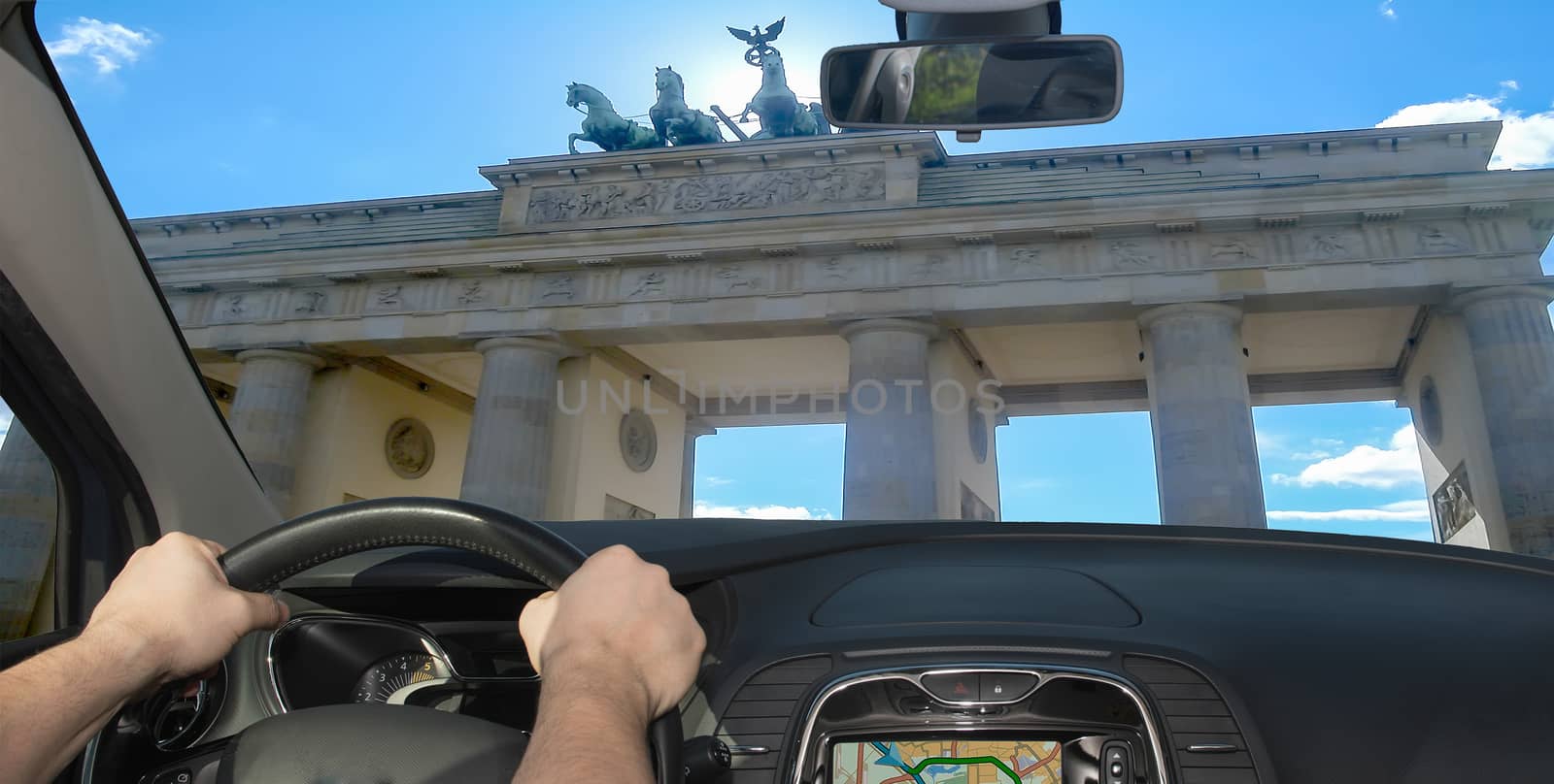 Driving a car towards Brandenburg Gate, iconic landmark in Berlin, Germany
