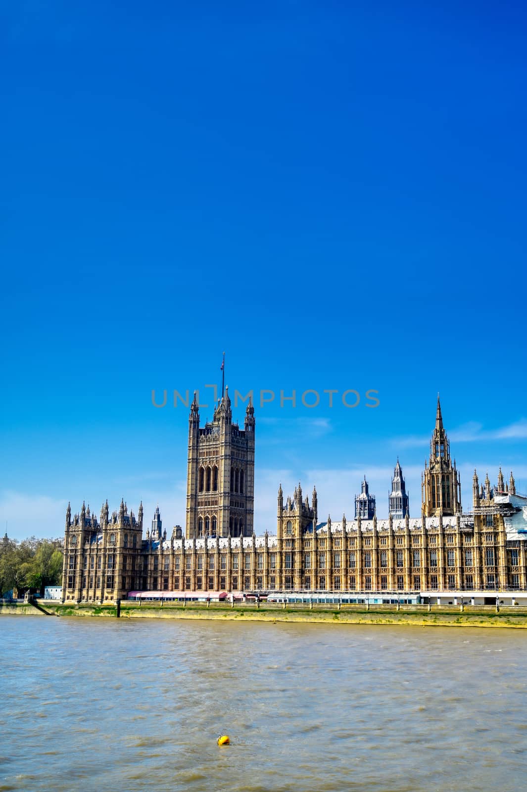 British Parliament along the River Thames on a sunny day in London, UK.