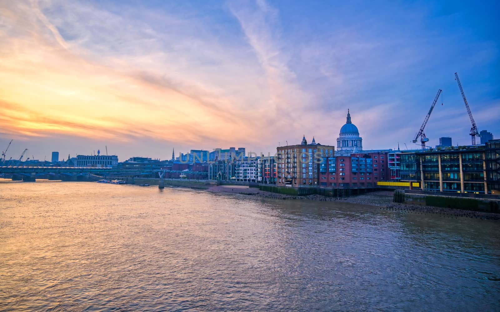 St. Paul's Cathedral across Millennium Bridge and the River Thames in London, UK.