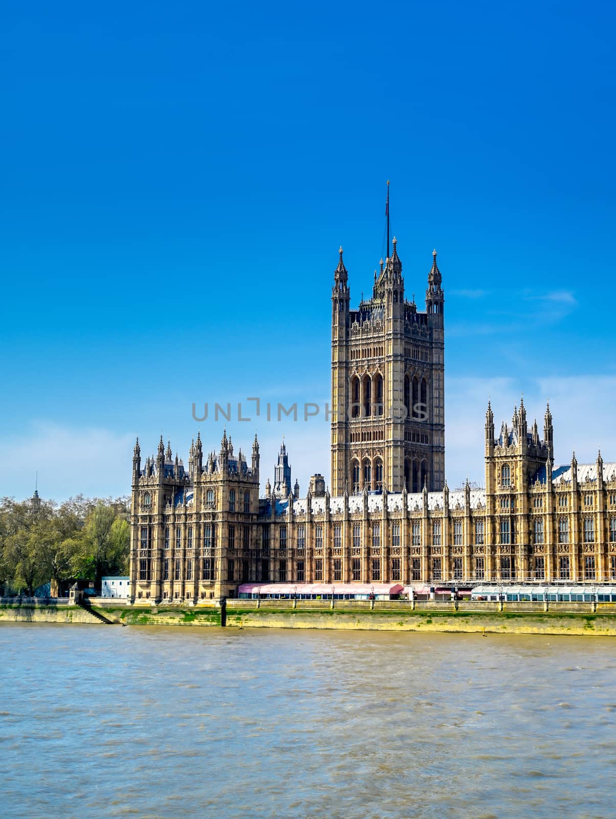 British Parliament along the River Thames on a sunny day in London, UK.