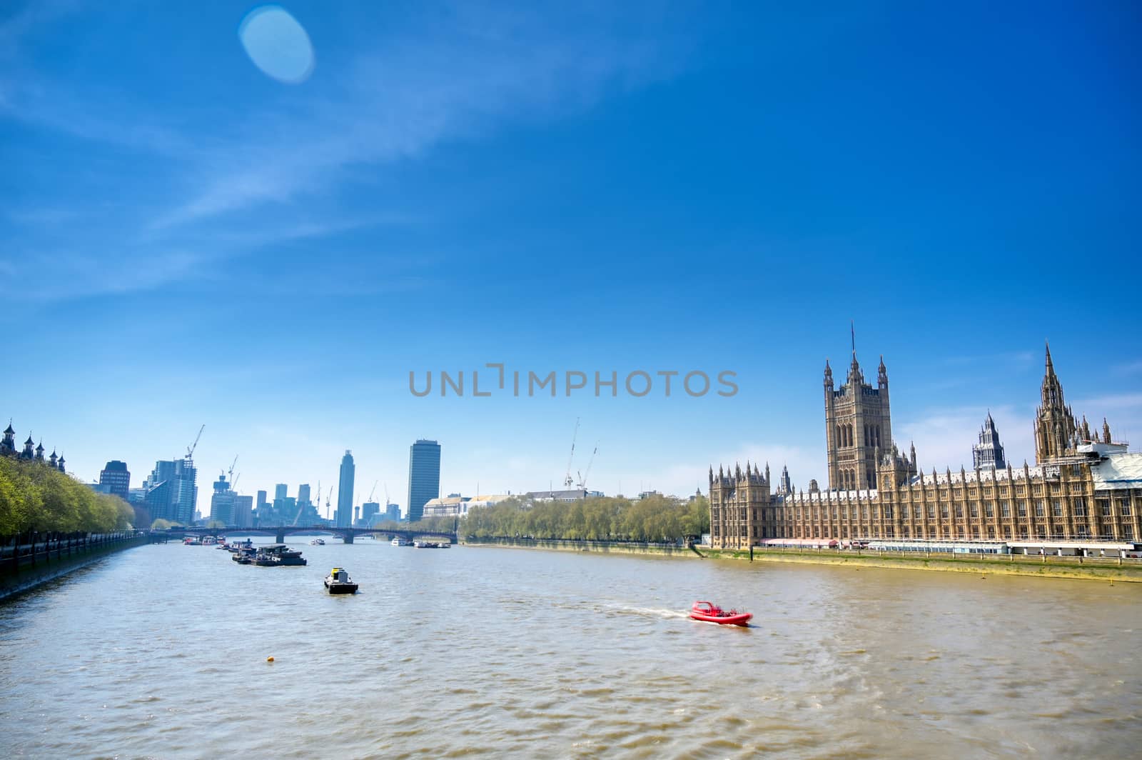 British Parliament along the River Thames on a sunny day in London, UK.