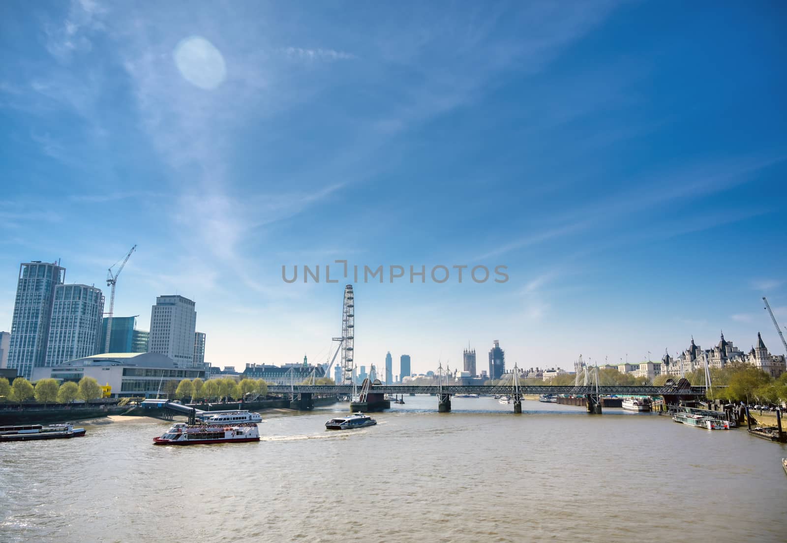 A view along the River Thames on a sunny day in London, UK.