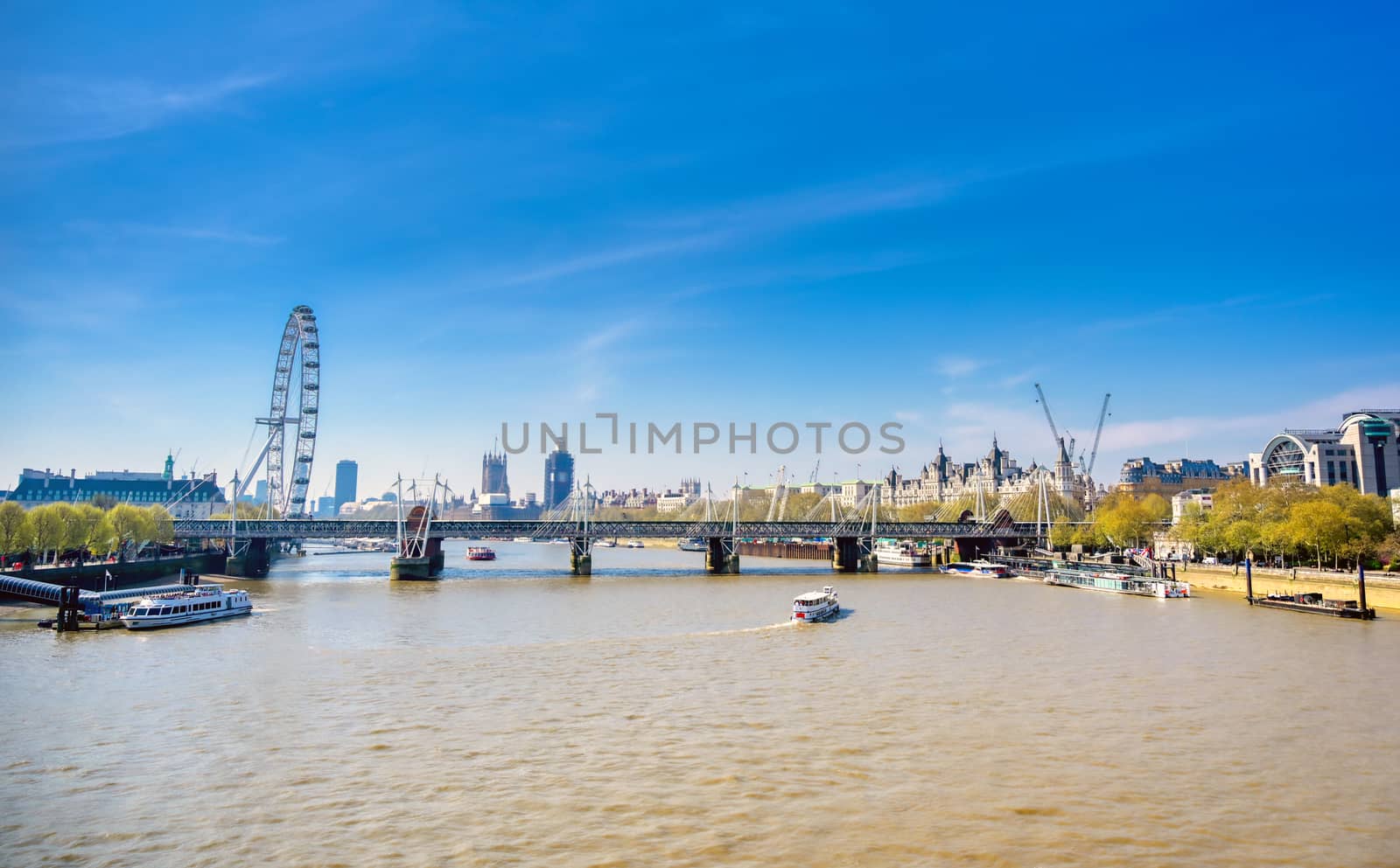 A view along the River Thames on a sunny day in London, UK.