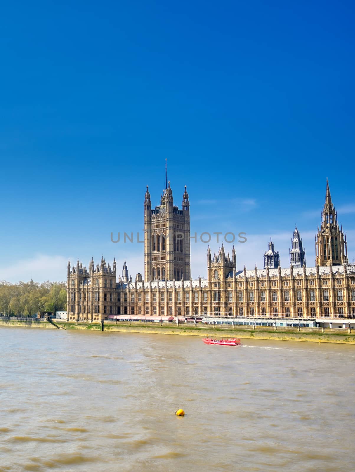 British Parliament along the River Thames on a sunny day in London, UK.