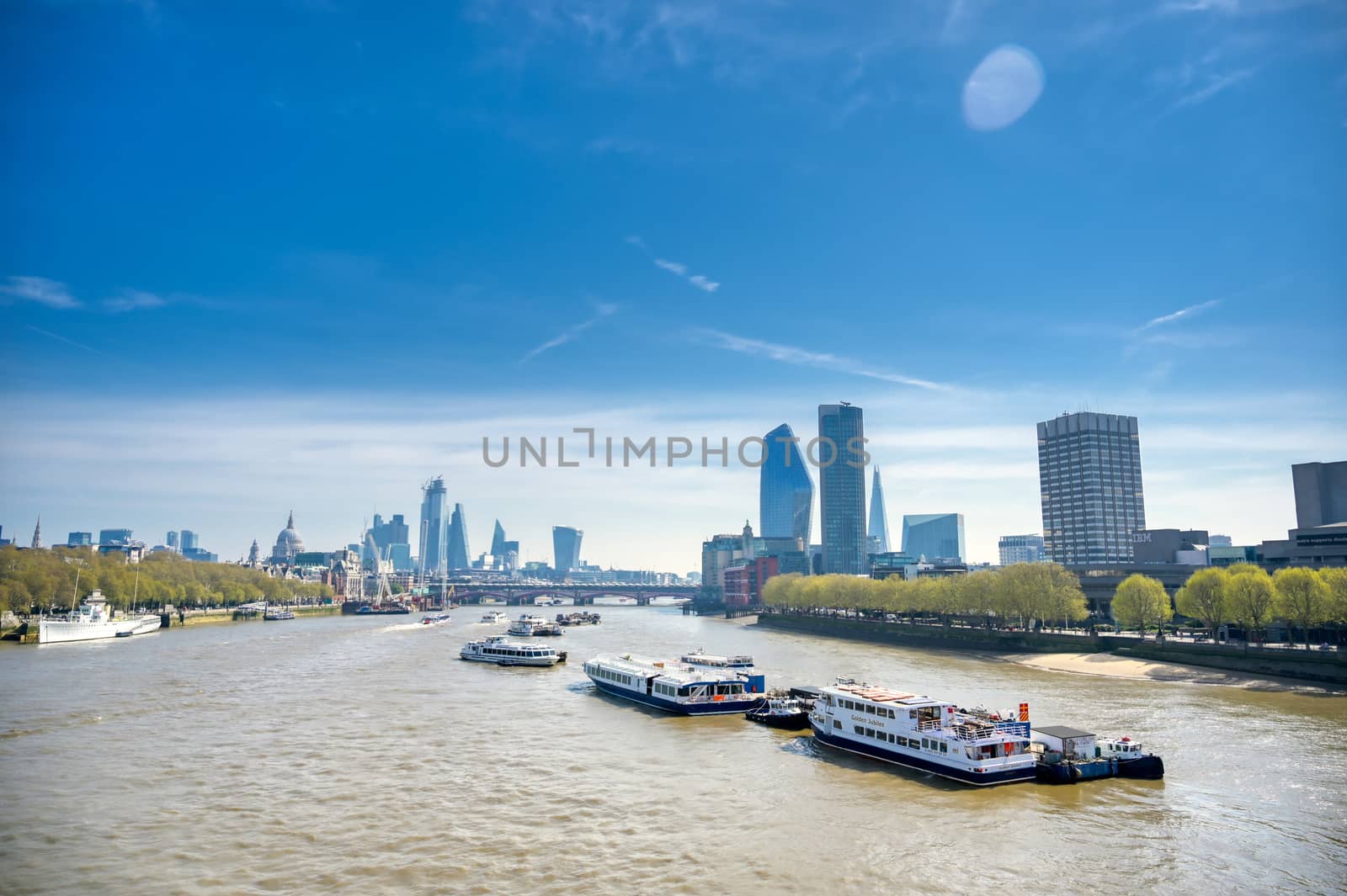 A view along the River Thames on a sunny day in London, UK.