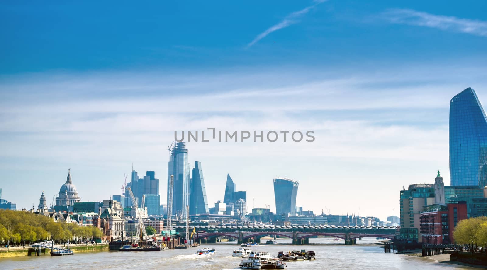 A view along the River Thames on a sunny day in London, UK.