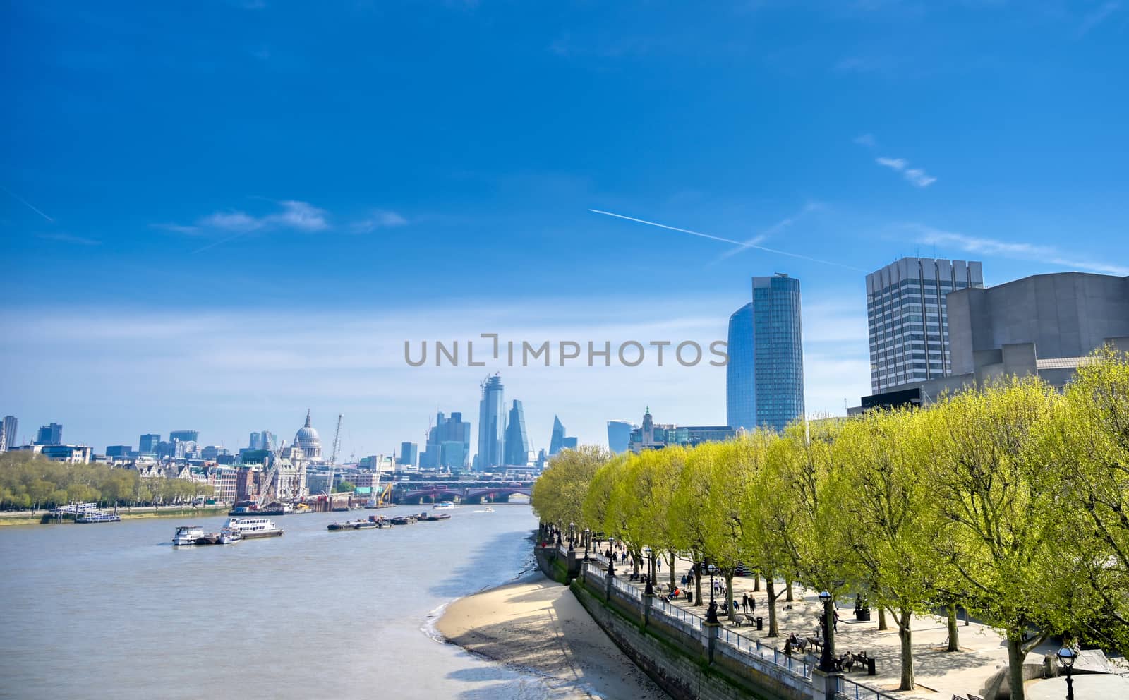 A view along the River Thames on a sunny day in London, UK.