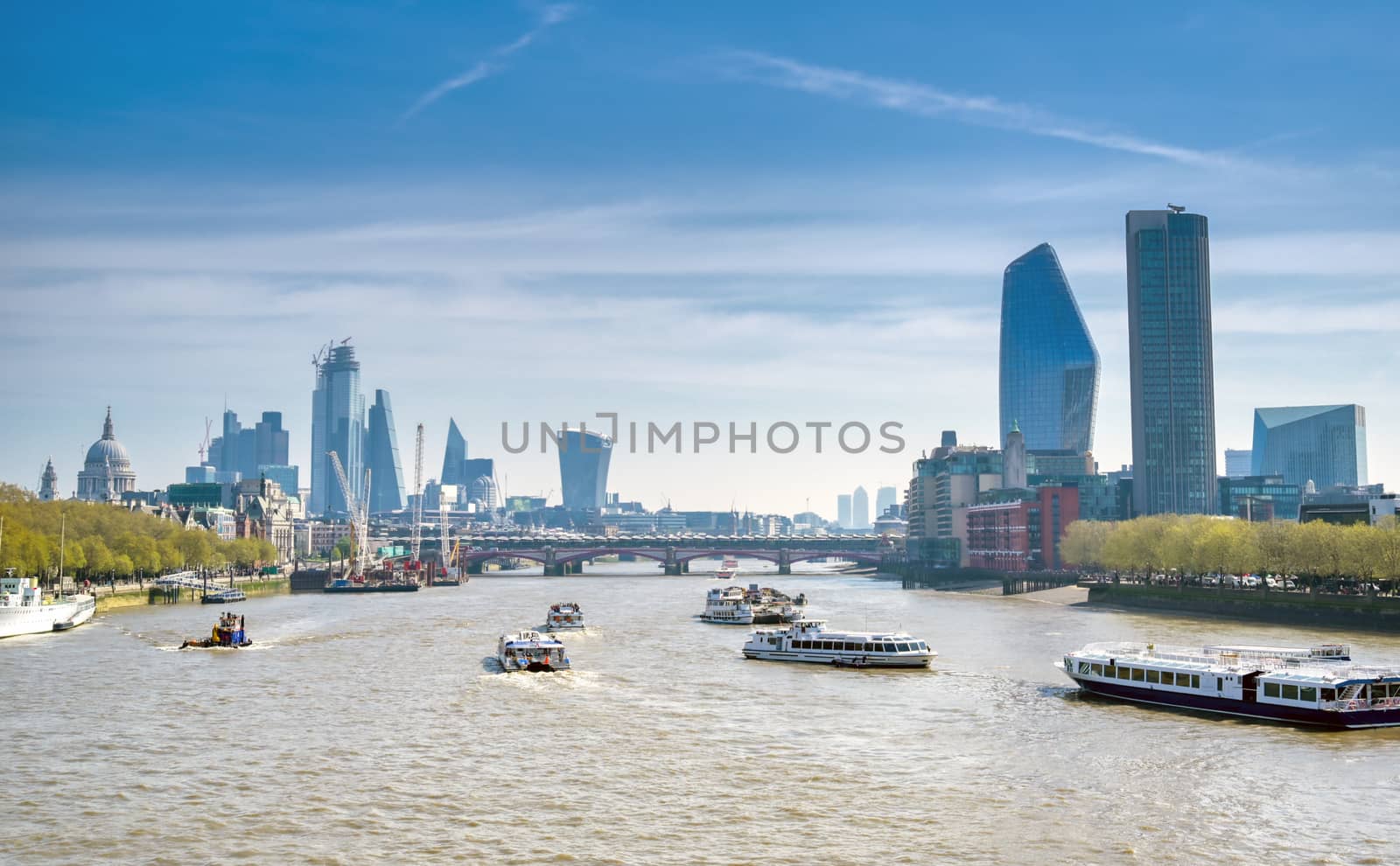 A view along the River Thames on a sunny day in London, UK.