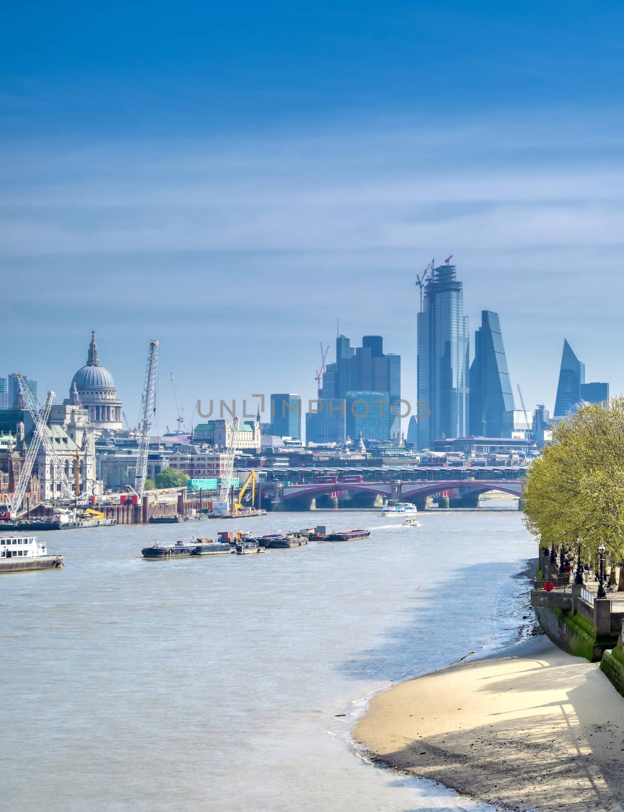 A view along the River Thames on a sunny day in London, UK.