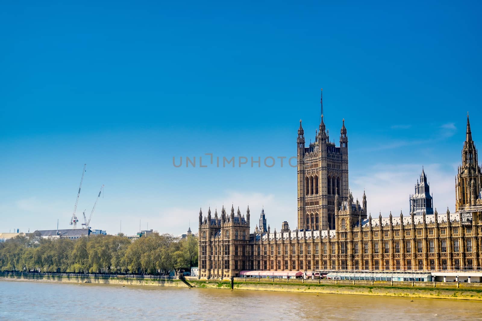 British Parliament along the River Thames on a sunny day in London, UK.