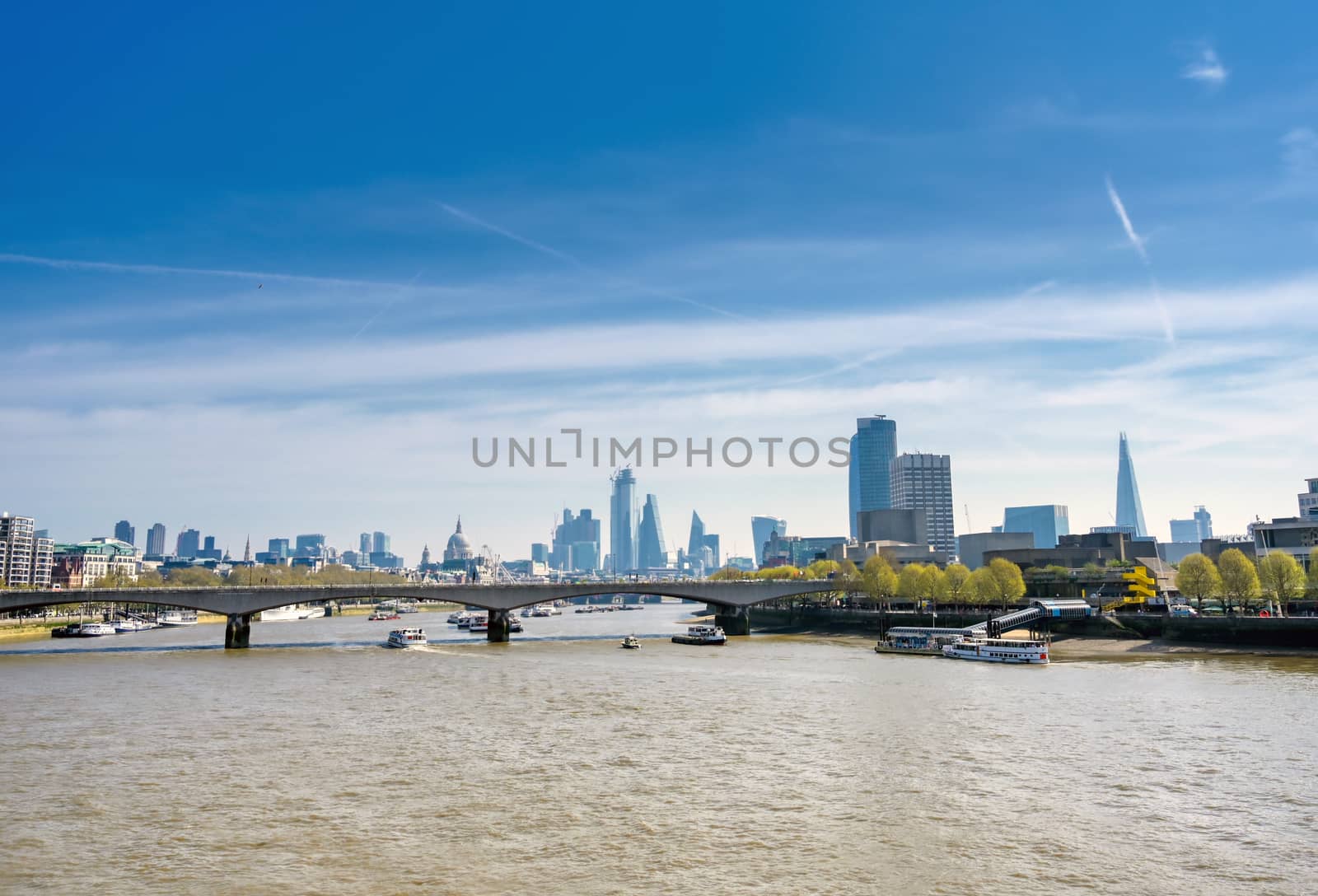 A view along the River Thames on a sunny day in London, UK.